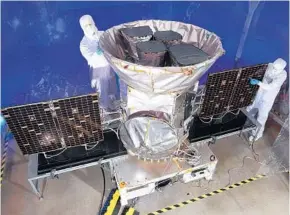  ?? NASA ?? Technician­s work on the Transiting Exoplanet Survey Satellite, aka Tess. The spacecraft will search for planets around the brightest stars that are closest to Earth.