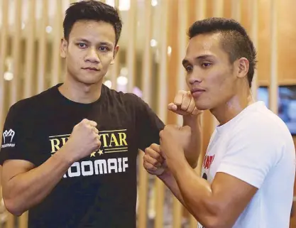  ?? JOEY MENDOZA ?? Jeson Umbal (right) poses with Muhammad Ridhwan of Singapore during the press conference and open workout yesterday at the Kerry Sports Shangri-La at the Bonifacio Global City.