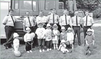  ??  ?? It was yellow hat day for the fire brigade last Saturday when the Lamlash team went to the Whiting Bay Playgroup fete where they found plenty youngsters eager to wear a fireman’s yellow helmet. B21twe03