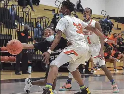  ?? PETE BANNAN - MEDIANEWS GROUP ?? Phoenixvil­le’s Elijiah Martin, left, attempts to make a pass around Chester’s Karell Watkins. The Clippers rolled to a 73-40victory over the Phantoms in the District 1Class 5A semifinals.