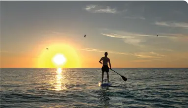  ?? ?? PADDLE BOARDER, ANNA MARIA ISLAND • VISIT FLORIDA/MAURICE RIVENBARK