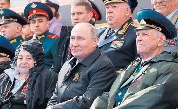  ?? ?? SHOW OF POWER: Russian president Vladimir Putin is surrounded by loyal generals as troops and armour parade through Red Square in Moscow.