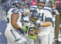  ?? JUSTIN REX/ASSOCIATED PRESS FILE PHOTO ?? Seahawks wide receiver Tyler Lockett, center, celebrates with teammates after catching a ball for a two-point conversion against the Texans during Sunday’s game in Houston.