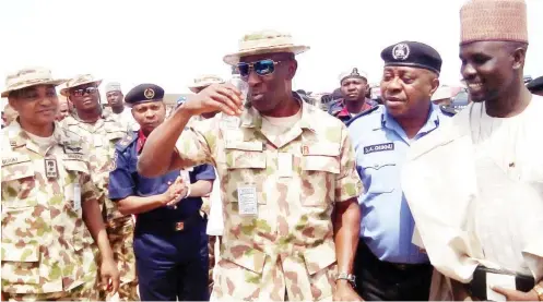 ?? Photo: NAN ?? General Officer Commanding, 7 Division of the Nigerian Army, Brig.-Gen. Victor Ezugwu, inaugurati­ng a renovated borehole at a primary school in the Bakassi Internally Displaced Persons (IDPs) camp in Maiduguri yesterday. With him are Commission­er of...