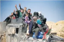  ?? Suhaib Salem / Reuters ?? Displaced Iraqi civilians flee their homes as Iraqi forces battle ISIL fighters in west Mosul yesterday.