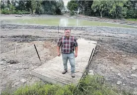  ?? MATHEW MCCARTHY WATERLOO REGION RECORD ?? Jim Barton stands on a dock that used to lead into a pond near his Cambridge home.