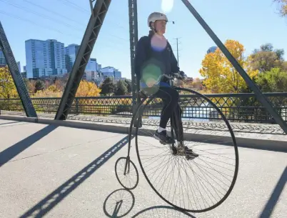  ?? Daniel Brenner, Special to The Denver Post ?? Paul Brekus rides his old-school, penny-farthing bike along a bridge Nov. 4 in north Denver.