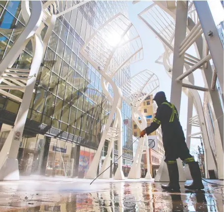  ?? GAVIN YOUNG ?? Stephen Avenue Mall gets a high-pressure wash on the weekend as the city prepared for the reopening of more businesses.