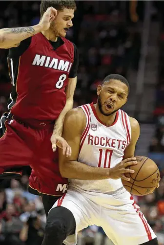  ?? Yi-Chin Lee / Houston Chronicle ?? After missing the past two games with a sore back, the Rockets’ Eric Gordon, right, gets a physical welcome back by Heat guard Tyler Johnson during the first half Wednesday night at Toyota Center.