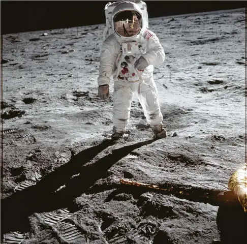  ?? NASA ?? Astronaut Buzz Aldrin, the second man to walk on the moon, is photograph­ed on the lunar surface by fellow astronaut Neil Armstrong. Armstrong, the first man to walk on the moon, is reflected in Aldrin’s visor.