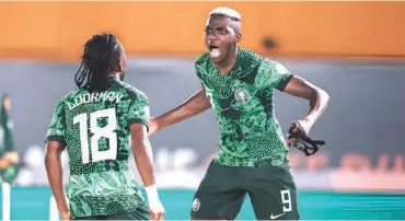  ?? ?? Victor Osimhen celebratin­g passionate­ly with Ademola Lookman during the win over Cameroon yesterday