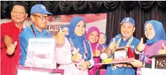  ??  ?? Normala (right) presents a souvenir to Hajiji, while (from left) Mijul, Bolkiah and Mas Ermieyati look on.