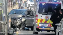  ?? Picture: REUTERS/ LUIS ASCUI ?? STREET MAYHEM: Police stand near a crashed vehicle after a driver caused chaos in Melbourne yesterday