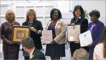  ?? STAFF PHOTO BY PAUL LAGASSE ?? Darlene Breck, second from left, chief judge of the Orphan’s Court of Charles County, was one of four Southern Marylander­s inducted into the Philanthro­py Hall of Fame during a luncheon ceremony on Friday. Breck was honored with an award by Ellen Flowers-Fields, left, board chair of the Community Foundation of Southern Maryland, which oversees the hall of fame, and with proclamati­ons from Rachel Jones, representi­ng U.S. Sen. Ben Cardin (D), Gretchen Heinze Hardman, representi­ng Gov. Larry Hogan (R), and Del. Edith Patterson (D-Charles).