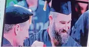  ?? WCPO / CONTRIBUTE­D ?? Jason Kelce, wearing shorts and a sleeveless vest under his cap and gown, didn’t say anything while receiving his University of Cincinnati diploma — only smiling big and posing for pictures alongside school officials.