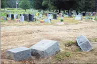  ?? Ned Gerard / Associated Press ?? In this Oct. 2, 2018, file photo, toppled headstones rest on the ground in Park Cemetery in Bridgeport. The former caretaker of the cemetery is facing a new charge of embezzling more than $60,000 from the cemetery.