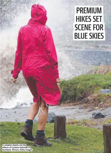  ?? ?? A resident checks out the effects of Cyclone Gabrielle in Auckland. Picture: Getty Images