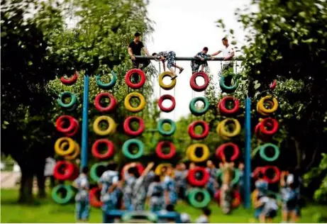  ??  ?? I’m so tyre-d: Part of the obstacle course at a youth summer camp in china run mainly by former military, police and fire fighters. — ePa