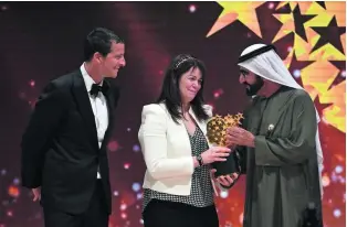  ?? Martin Dokoupil / AP Photo ?? Sheikh Mohammed bin Rashid, Vice President and Ruler of Dubai, presents a Global Teacher Prize worth $1 million to Canadian schoolteac­her Maggie MacDonnell.