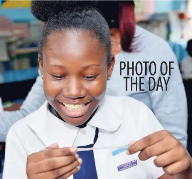  ?? ALLEN/PHOTOGRAPH­ER ?? Sharnel Bryce, student at the Elletson Primary School in Kingston, was very excited when she saw her Grade Six Achievemen­t Test result, yesterday. IAN