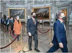  ?? Sarah Silbiger / Getty Images ?? The House impeachmen­t managers walk to the Senate chamber on Monday.