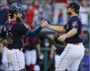  ?? DAVID DERMER — ASSOCIATED PRESS ?? Indians relief pitcher Brad Hand, right, is congratula­ted by catcher Eric Haase after defeating the Tigers, 15-0, on Sept. 15 in Cleveland.