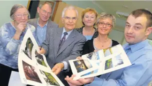  ??  ?? ●●The judges look over the winning pictures for the 2009 Springhill Hospice calendar