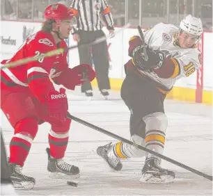  ?? | ROSS DETTMAN/ WOLVES ?? Wolves winger Yannick Veilleux gets off a shot against the Checkers’ Phil DiGiuseppe.