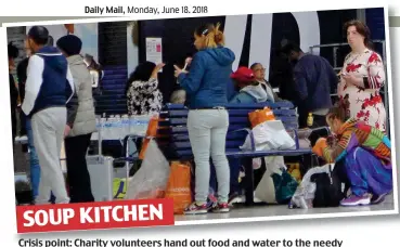  ??  ?? Crisis point: Charity volunteers hand out food and water to the needy