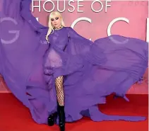  ?? ?? Lady Gaga in a Very Peri draped maxidress with a flowing cape from Gucci’s spring 2022 collection.