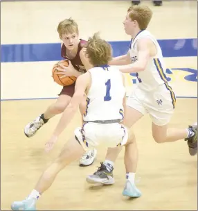  ?? Neal Denton/The Baxter Bulletin ?? Siloam Springs junior guard Nathan Hawbaker is trapped by Mountain Home’s Coben Inskeep (No. 1) and Blaine Tate (right) during Saturday’s game in Mountain Home. The Bombers defeated the Panthers 51-49.