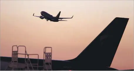  ?? Glenn Koenig Los Angeles Times ?? A PLANE leaves John Wayne Airport. Orange County has filed a petition to block revised air traffic plans for planes using the facility.