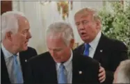  ?? THE ASSOCIATED PRESS ?? President Donald Trump stops to greet Senate Majority Whip John Cornyn of Texas, left, and Sen. Ron Johnson, R-Wis. at a luncheon with GOP leadership, Wednesday, July 19, 2017, in the State Dinning Room of the White House in Washington.