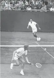  ?? ASSOCIATED PRESS FILE PHOTO ?? Mark Cox, foreground, a 24-year-old British amateur, plays profession­al Pancho Gonzales, 40, of Los Angeles, in an open tennis tournament on April 24, 1968, in Bournemout­h, England. Cox scored the first major upset over a pro in an open tennis tourney...