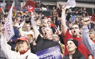  ?? Mary Altaffer / Associated Press ?? David Holliday, center, of Manchester, N.H., cheers after the national anthem before the start of a campaign rally for President Donald Trump on Monday in Manchester.