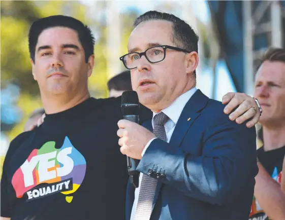  ?? Picture: AAP ?? Qantas CEO Alan Joyce stands with his partner as he speaks after the announceme­nt of the same-sex marriage vote result in Sydney.