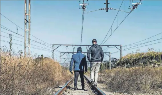  ??  ?? Off track: Security guards patrol Prasa rail tracks. Many of the guards who protect the rail agency’s property are employed by outside companies but they would prefer to be permanent employees of Prasa. Photo: Delwyn Verasamy