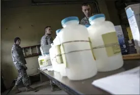  ?? ASSOCIATED PRESS FILE PHOTO ?? Water analysis test kits for Flint, Mich., residents to pick up for lead testing in their drinking water are set out on a table at Flint Fire Department Station No. 1 in Flint.