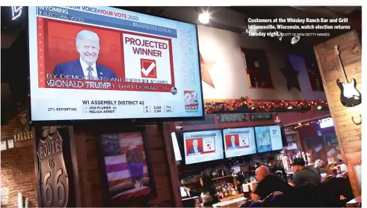  ?? SCOTT OLSON/ GETTY IMAGES ?? Customers at the Whiskey Ranch Bar and Grill in Janesville, Wisconsin, watch election returns Tuesday night.