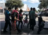  ??  ?? Immigrant families from Central America walk to the Catholic Charities Humanitari­an Respite Center on June 22 in McAllen, Texas. Many of the immigrants were also given bus tickets to cities around the United States.