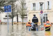  ?? Mehdi Fedouach / AFP / Getty Images ?? A rescue team uses a boat to aid residents in the flooded town of Saintes in western France.