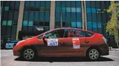  ?? U-T FILE SAM HODGSON ?? A protester for rent relief in a “Food Not Rent” car caravan drives through downtown San Diego in May.