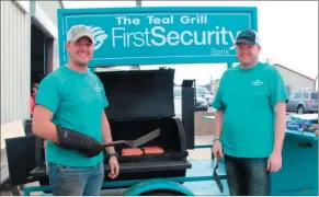  ??  ?? From left, Tim Reilly and Brandon Moss work First Security Bank’s Teal Grill during the expo. First Security Bank provided lunch for attendees.