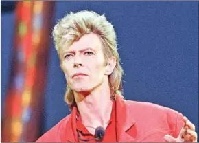  ?? BERTRAND GUAY/AFP TOBIAS SCHWARZ/AFP ?? British singer David Bowie performs on stage during a concert in La Courneuve on July 03, 1987.