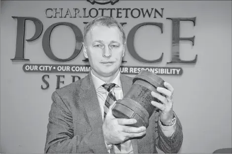  ?? JIM DAY/THE GUARDIAN ?? Charlottet­own Police Deputy Chief Brad MacConnell holds a replica of the pipe bomb Roger Bell planted in June 1996 at the Speedy Propane bulk plant in Charlottet­own. The bomb was larger than the first three Bell planted between 1988 and 1995.