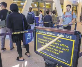  ?? Irfan Khan Los Angeles Times ?? STUDENTS line up at the cashier’s office at Cal State L.A. California State University trustees approved plans to increase enrollment by 21,000 students.