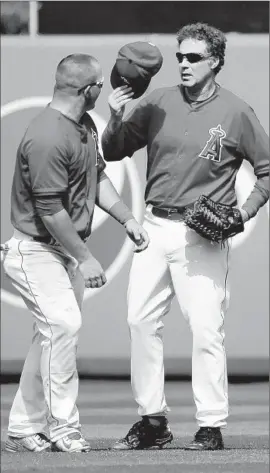  ?? Chris Carlson Associated Press ?? ACTOR WILL FERRELL replaces the Angels’ Mike Trout, right, in center field during a spring training game against the Chicago Cubs at Tempe, Ariz.