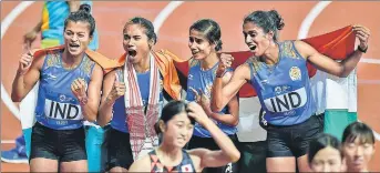  ??  ?? (Top) The goldwinnin­g 4x400m Indian women’s team celebrates its victory. (Right) Jinson Johnson takes a victory lap after winning the 1,500m event at the Asian Games. PTI/AP PHOTOS