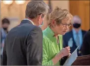  ?? AP-Alyssa Pointer/Atlanta Journal-Constituti­on via AP ?? Georgia Gov. Brian Kemp whispers to Kathleen Toomey, commission­er for the Georgia Department of Public Health, during a news conference at the Georgia Capitol, on March 16 .