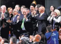  ?? Pavel Golovkin ?? The Associated Press Delegates from North America — Canada, Mexico and the United States — rejoice after winning a joint bid to host the 2026 World Cup.